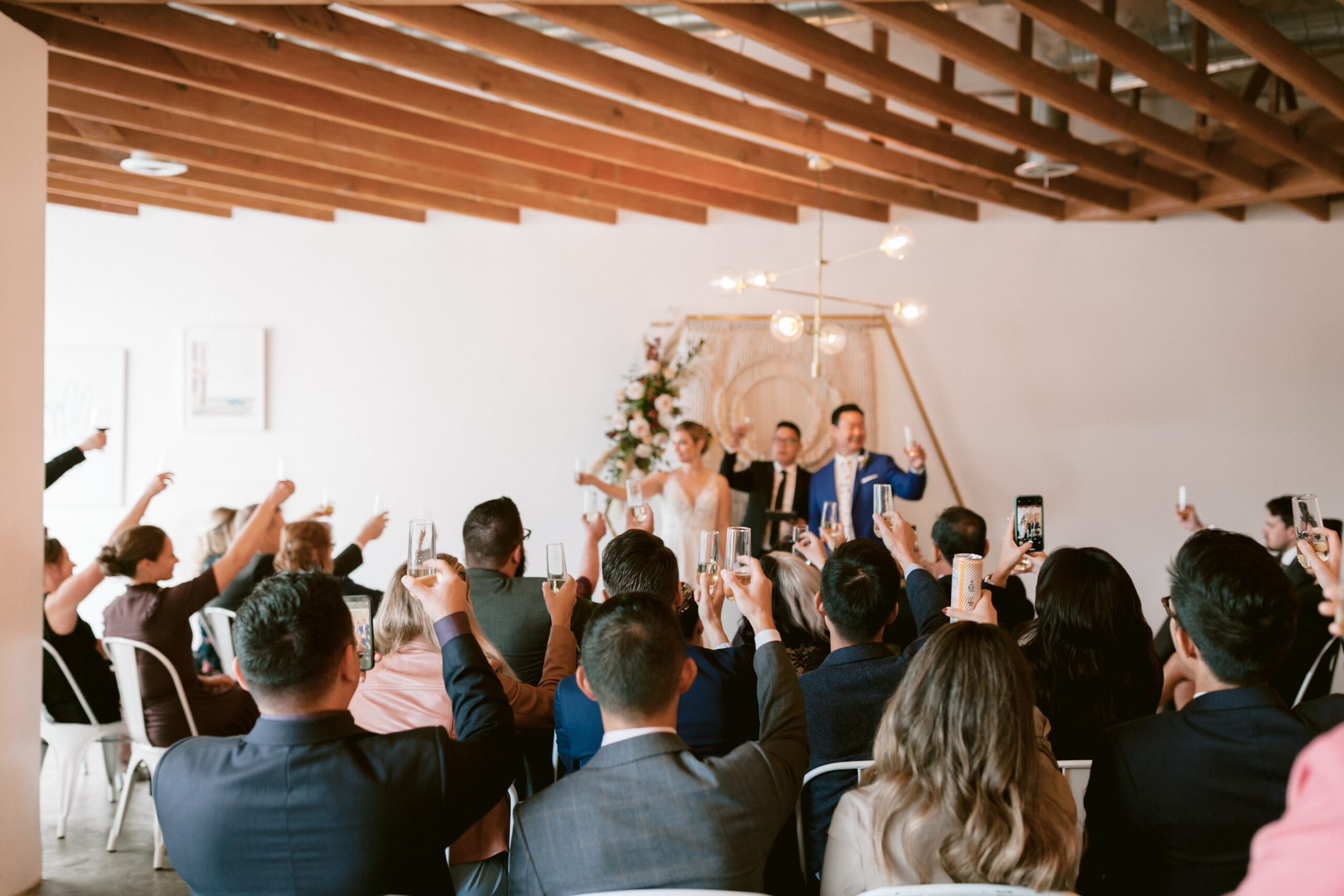 bride and groom toast to their guests at intimate wedding ceremony