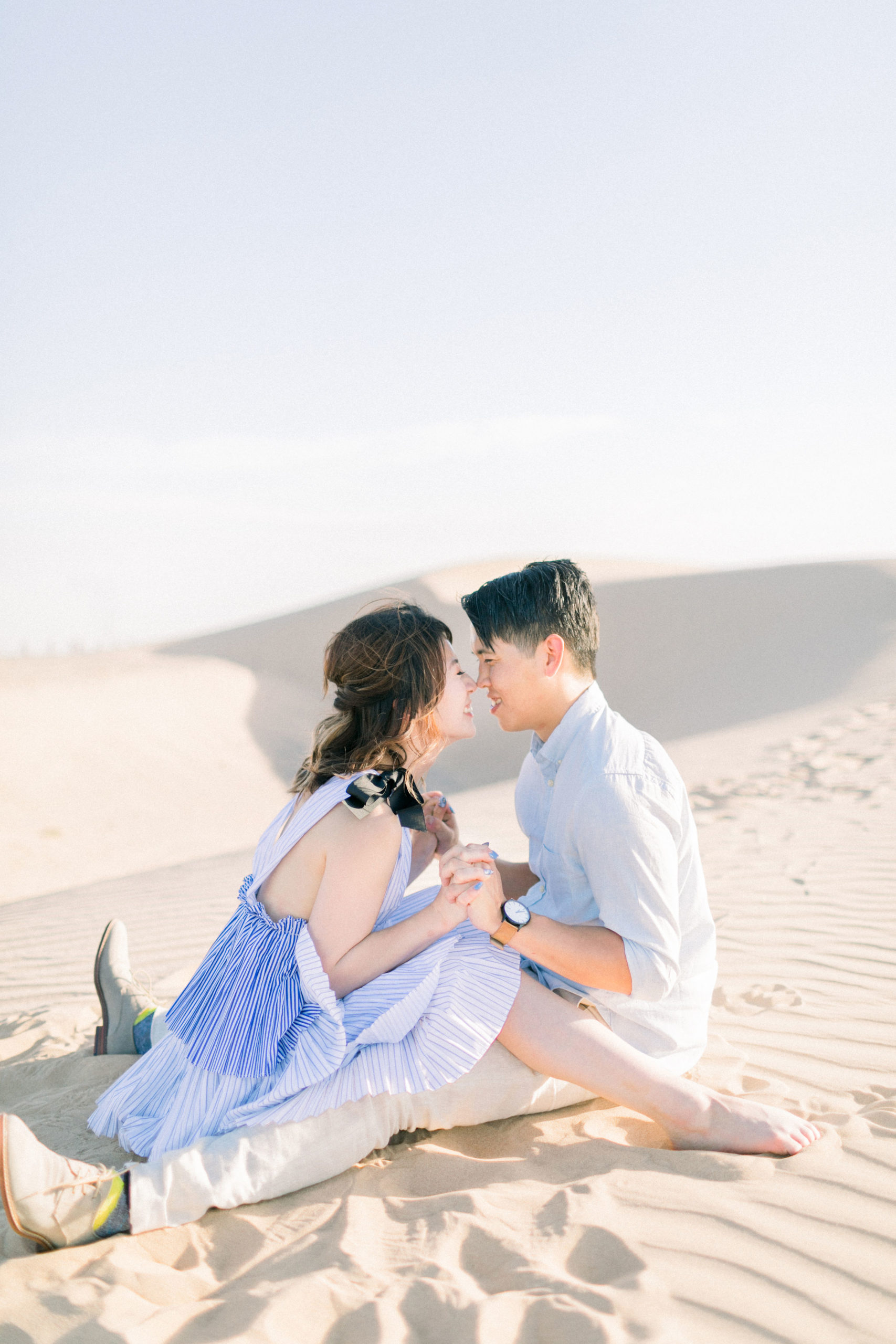 Couple nose to nose in sand dunes