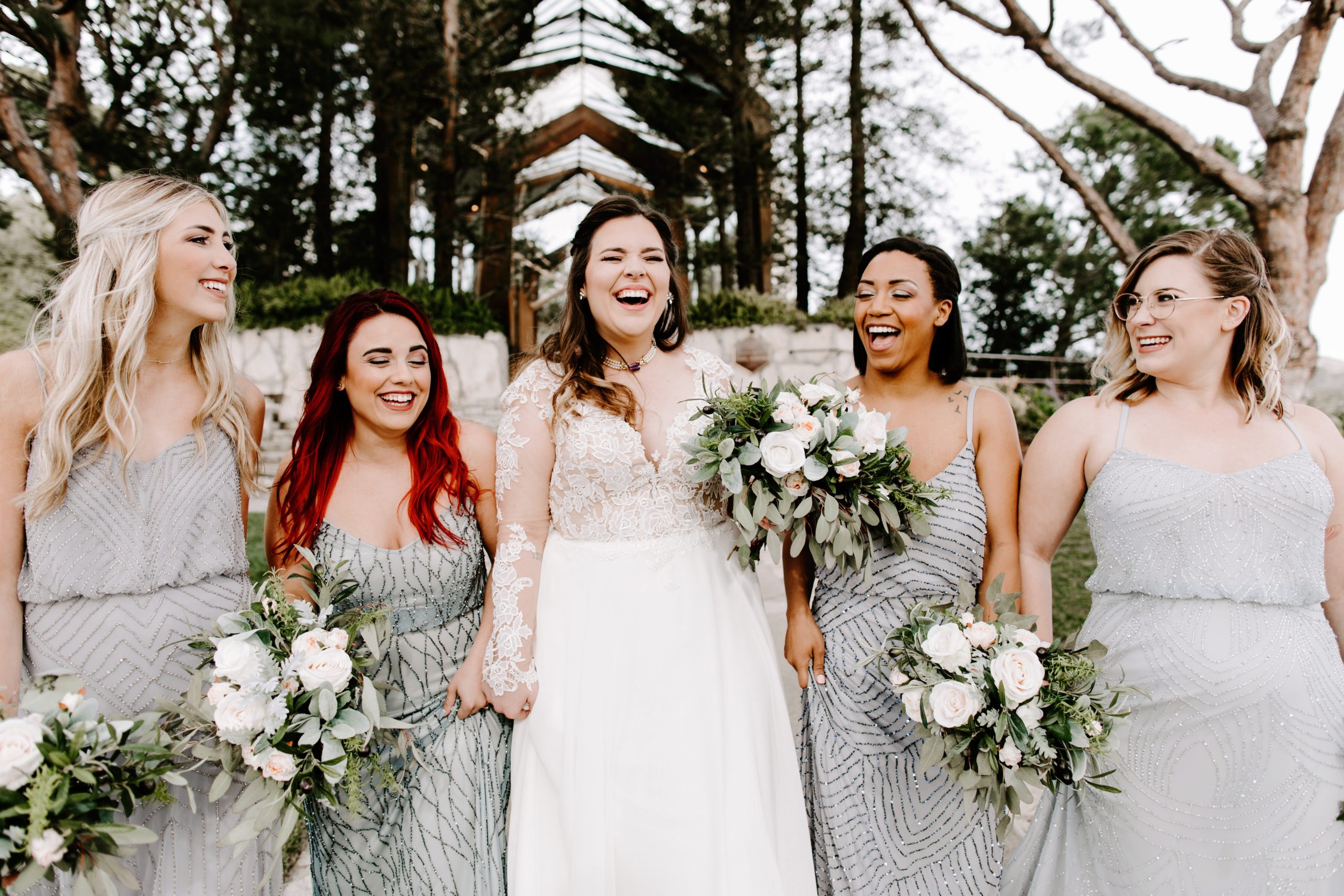 Laughing bride with bridesmaids at Wayfarers Chapel
